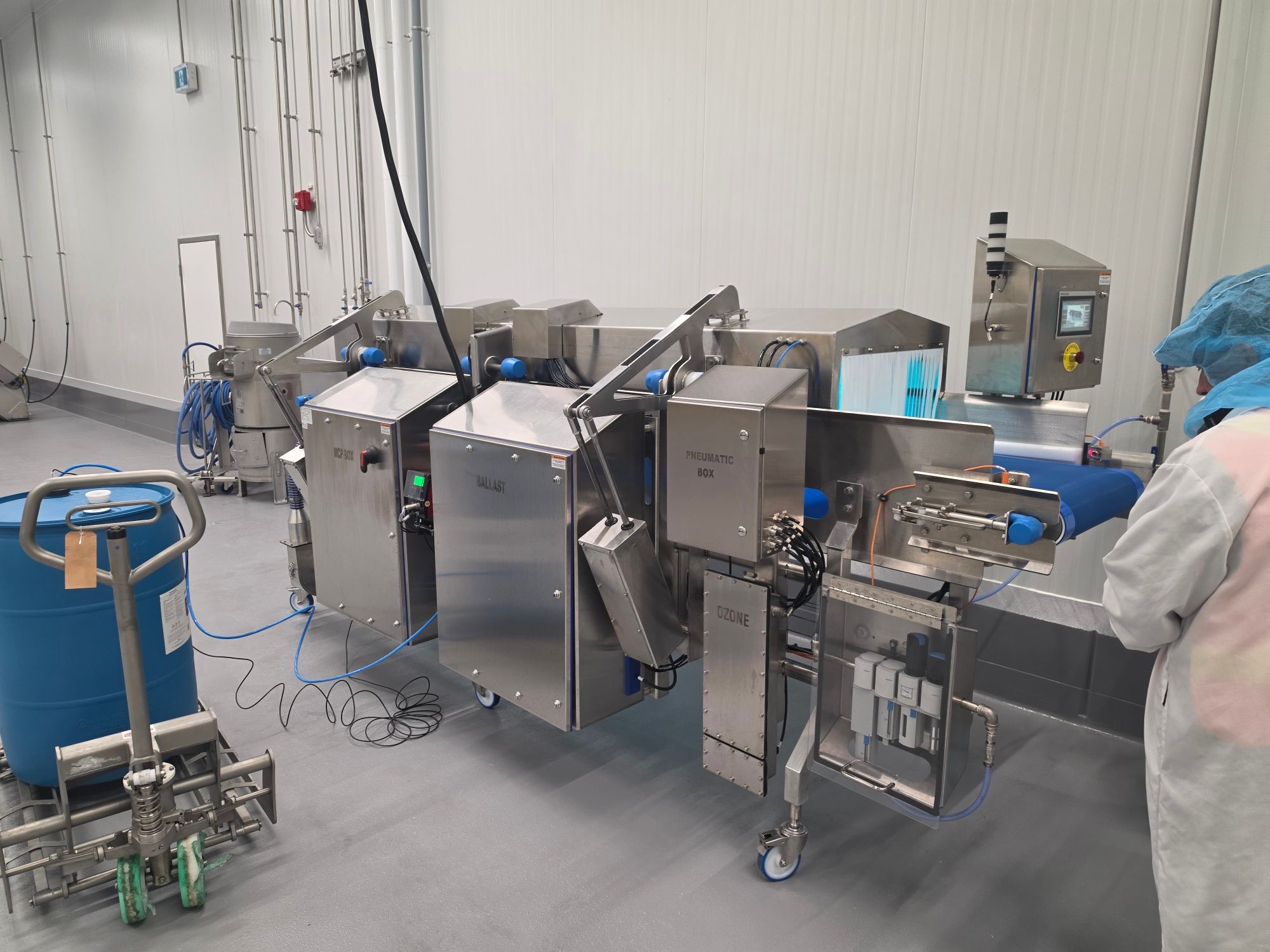 Clean Flow system with its control, ballast, pneumatic and ozone cabinets alongside the conveyor